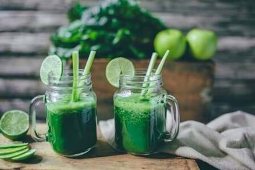 Blender, smoothie and healthy black woman taste juice for green